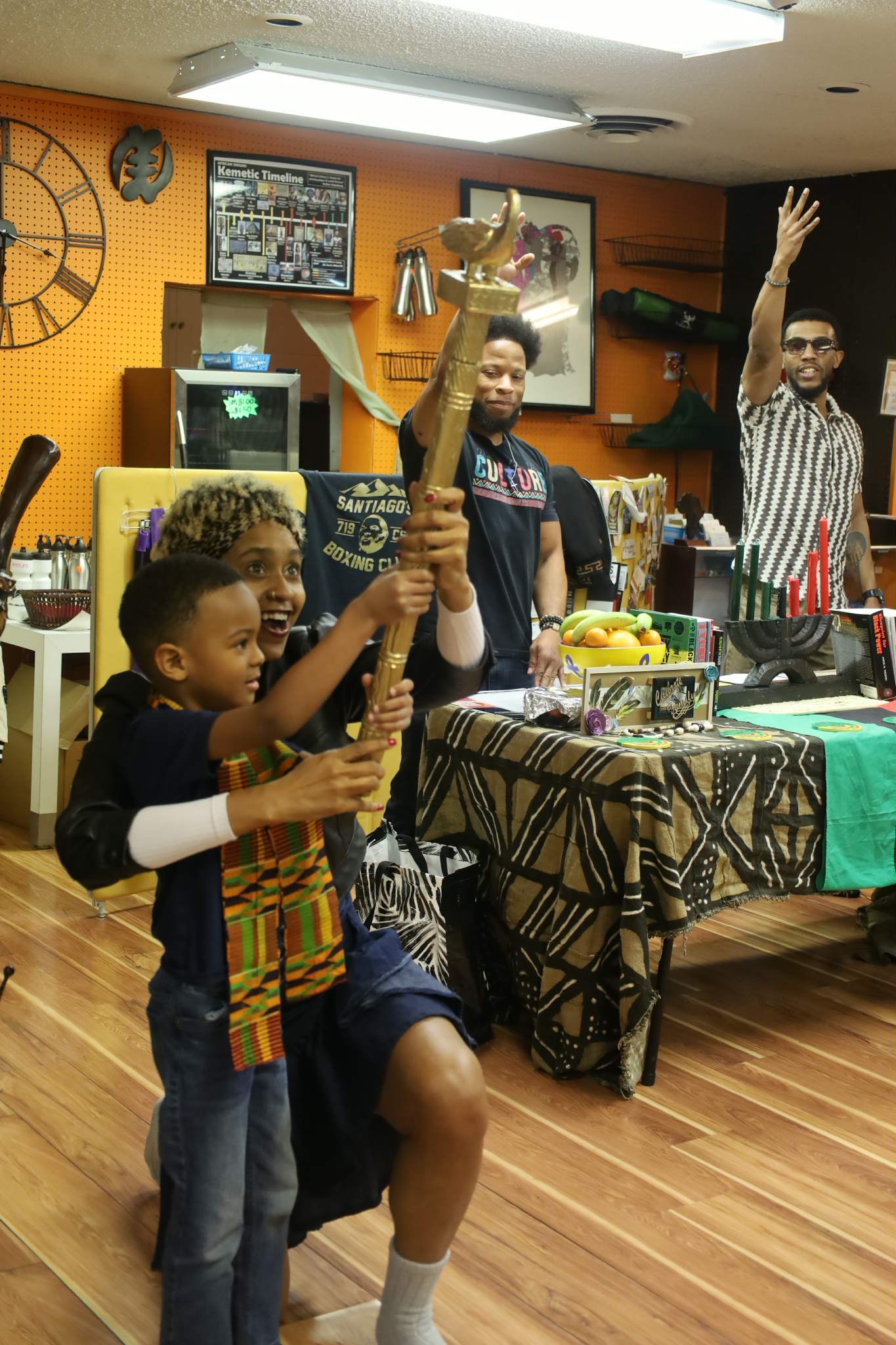 Youth holding ceremonial staff at cultural event