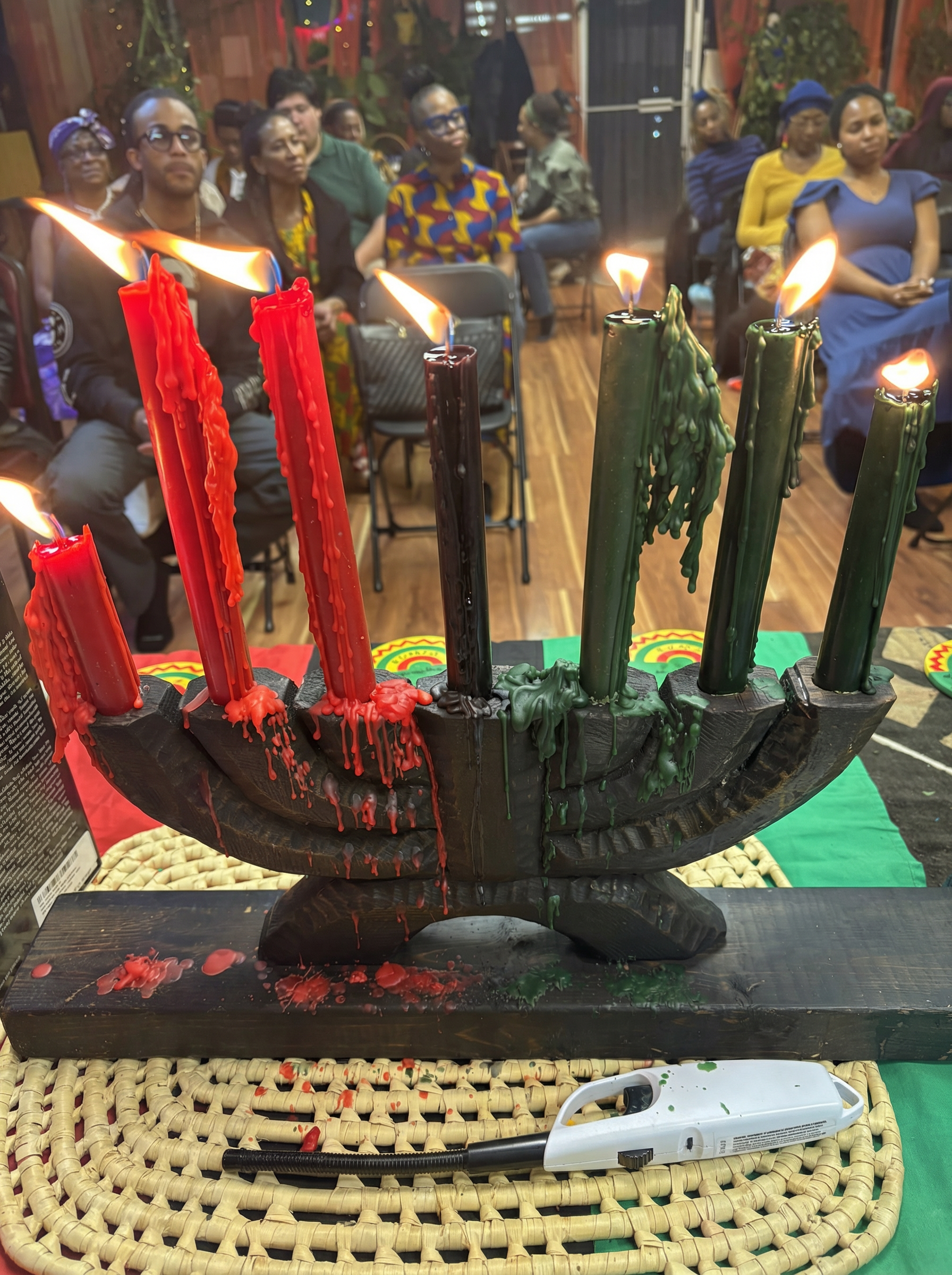 Kinara with seven candles lit at Kwanzaa celebration